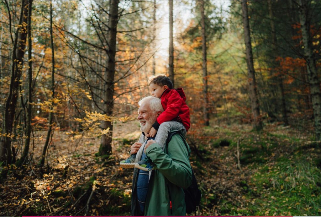 Grandpa and son walking in the woods 