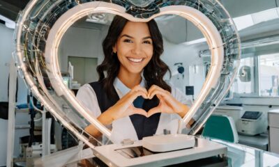 Women showing a heart symbol with her hands in front of 3d printed organs