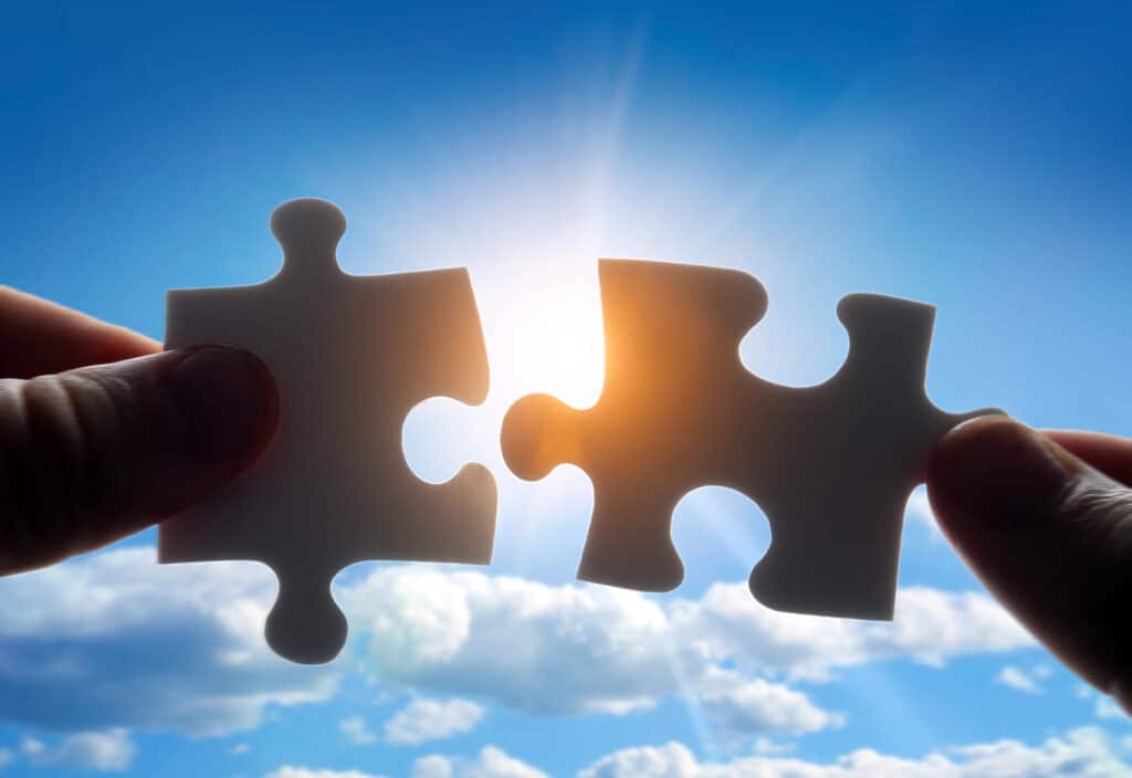 How Do I Become an Entrepreneur concept: a close-up of two puzzle pieces being put together